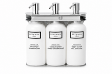 Load image into Gallery viewer, Wall Mounted 16 oz Triple Oval Hotel Amenity Dispenser | Polished Stainless Steel | Aquamenities
